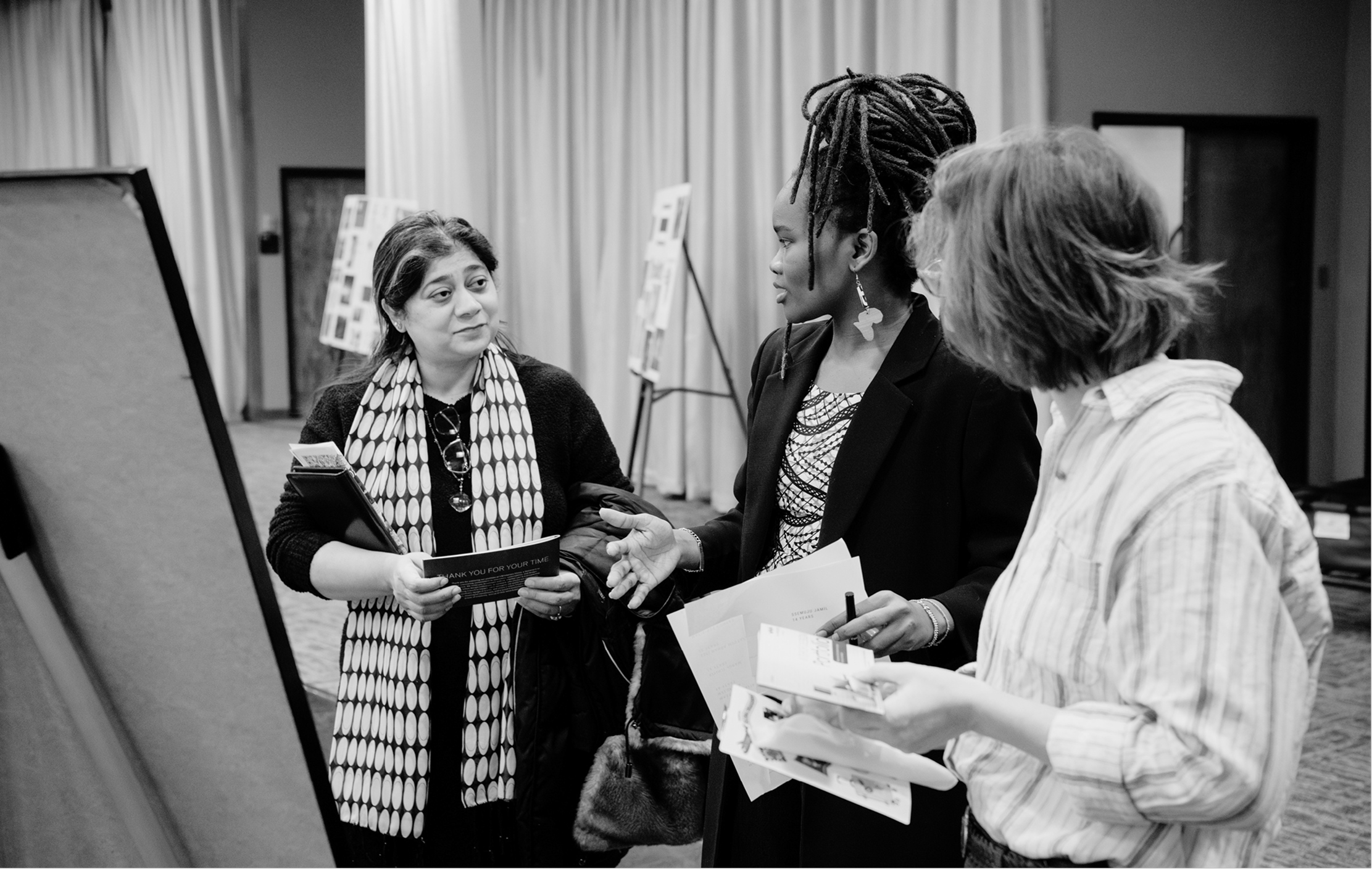 Victoria Merab Akinyi in a formal handshake with colleagues